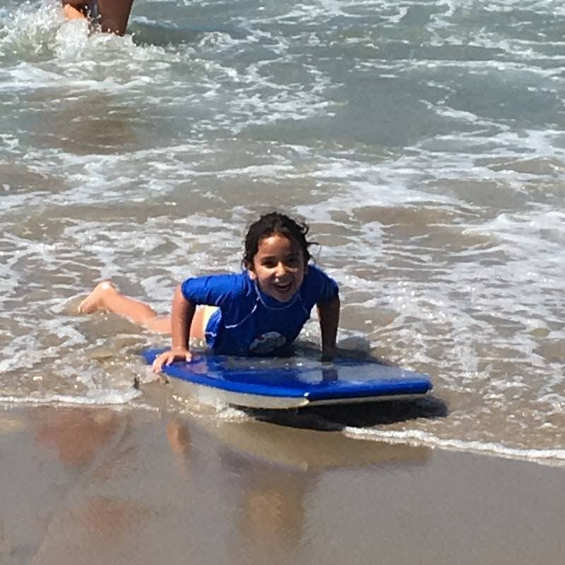 Boy boogie boarding at Fitness by the Sea Beach Camp