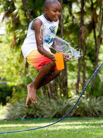 Water Activities For Kids - boy jumping with water