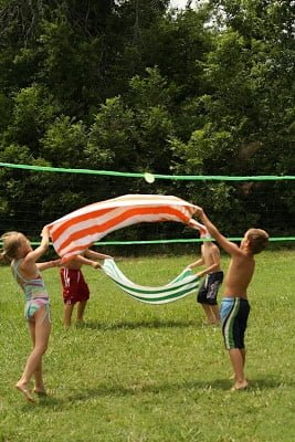 kids doing a water balloon toss outside